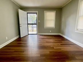 Louisville house for rent - A room with wooden floors and a white door.