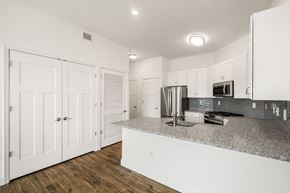 Middletown apartment for rent - A kitchen with white cabinets and a granite countertop.