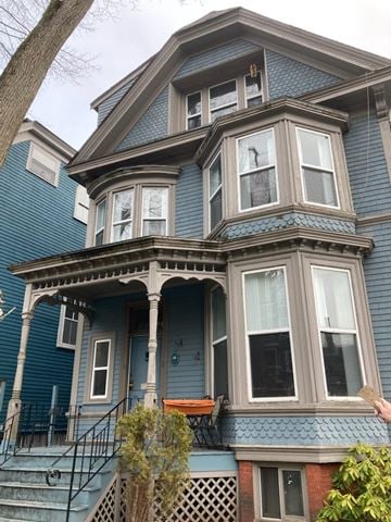 Halifax apartment for rent - A blue house with a porch and a balcony.