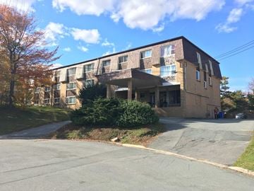 Halifax apartment for rent - A large apartment building with a parking lot in front.