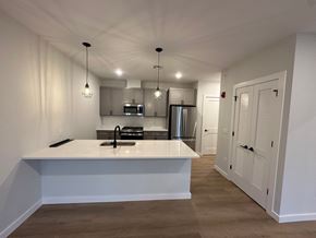Warwick apartment for rent - A kitchen with a white countertop and wooden flooring.