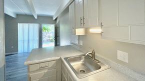Aurora apartment for rent - an empty kitchen with white cabinets and white appliances