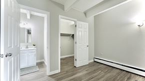 Aurora apartment for rent - an empty living room with wood flooring and a white door