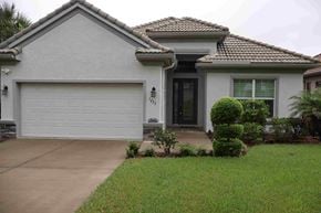 Hernando house for rent - a house with a driveway and a garage door in front of it