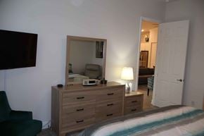 Hernando house for rent - a bedroom with a bed and a mirror and a dresser