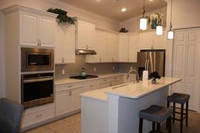 Hernando house for rent - a kitchen with white cabinets and a counter top