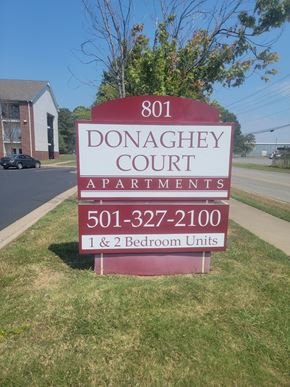 Conway apartment for rent - A sign for Donaghey Court Apartments with a phone number and a note that there are 1 and 2 bedroom units.