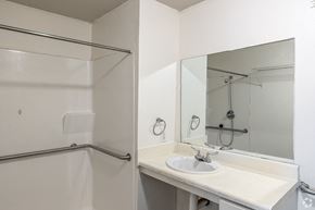 Conway apartment for rent - A white bathroom with a sink, mirror, and shower.