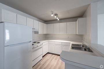 Conway apartment for rent - A kitchen with white appliances and cabinets.