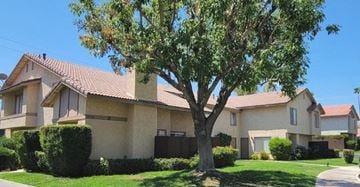 Palm Desert apartment for rent - a house with a tree in front of it