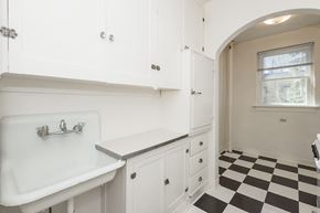 Denver apartment for rent - A white sink in a white bathroom with black and white checkered floor.