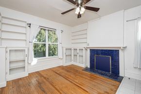 Denver apartment for rent - A room with a fireplace and wooden floors.