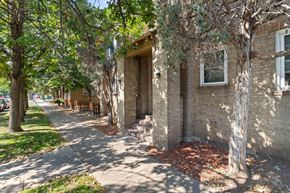Denver apartment for rent - a brick building with trees and a sidewalk