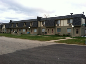 Grayslake apartment for rent - Apartment complex with a grey road in front.