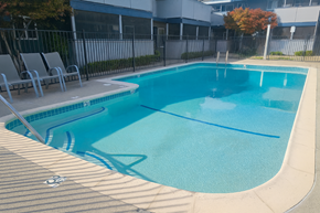 San Jose apartment for rent - A small pool with a brownish floor and a white fence.