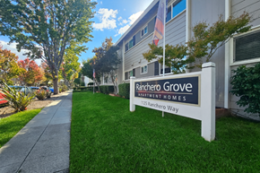 San Jose apartment for rent - A sign for Rancher Grove Apartment Homes stands in front of a building.