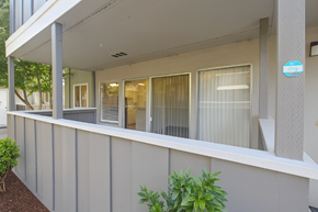 San Jose apartment for rent - A modern building with a balcony and a small garden.