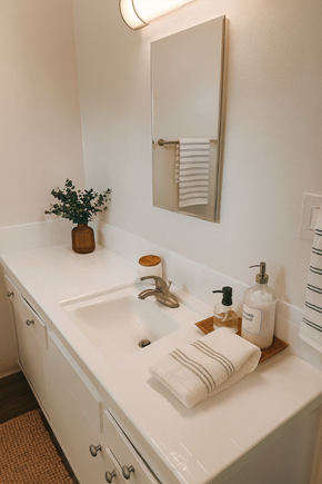 San Jose apartment for rent - A white bathroom with a sink, mirror, and towel.