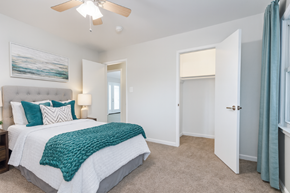 San Jose apartment for rent - A bedroom with a bed, a ceiling fan, and a painting on the wall.