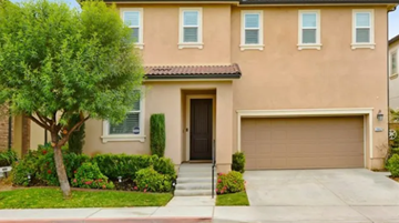 Corona house for rent - a house with a driveway and a garage door in front of it