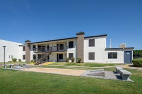 Phoenix apartment for rent - A modern building with a white exterior and a grey roof.