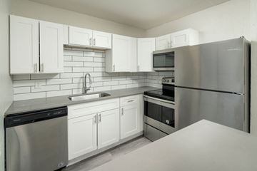 Phoenix apartment for rent - A kitchen with white cabinets and stainless steel appliances.