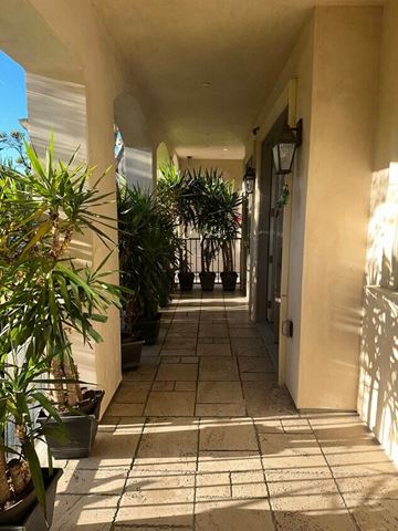 Westwood apartment for rent - a hallway with potted plants on either side of a building