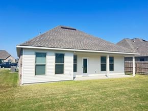 Lafayette house for rent - the front of a white house with a porch and a yard