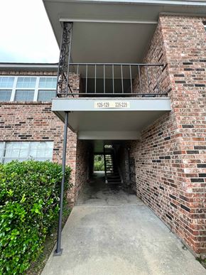 Lafayette apartment for rent - the entrance to a brick building with a balcony