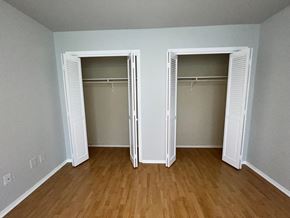 Lafayette apartment for rent - a bedroom with two closets and a hard wood floor
