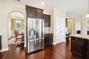 Maple Hill house for rent - a kitchen with a stainless steel refrigerator and wooden cabinets