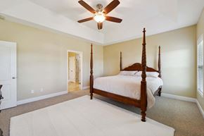 Maple Hill house for rent - a bedroom with a four poster bed and a ceiling fan