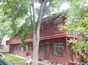 Boulder apartment for rent - a red brick house with a balcony and a tree