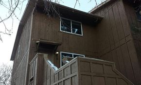 Boulder apartment for rent - A brown wooden house with a window and a door.