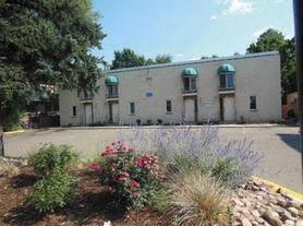 Boulder apartment for rent - a white building with plants in front of it