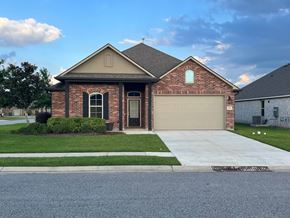 Youngsville house for rent - a house with a driveway and a garage door