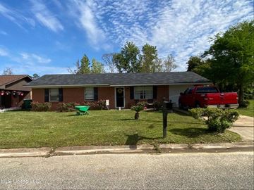 Gulfport house for rent - A red truck is parked in front of a house.