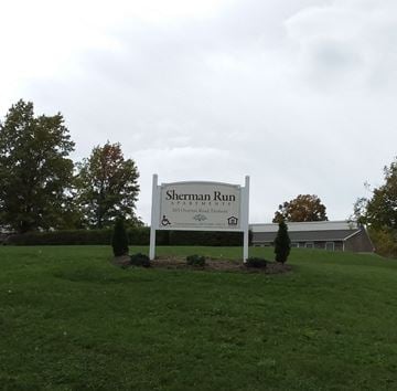 Dushore apartment for rent - the sign in front of the sherman run building