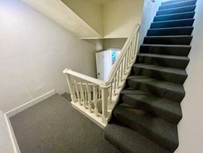 Louisville apartment for rent - A staircase with a white railing and black steps.