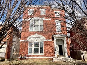 Louisville apartment for rent - A red brick house with a white door and windows.