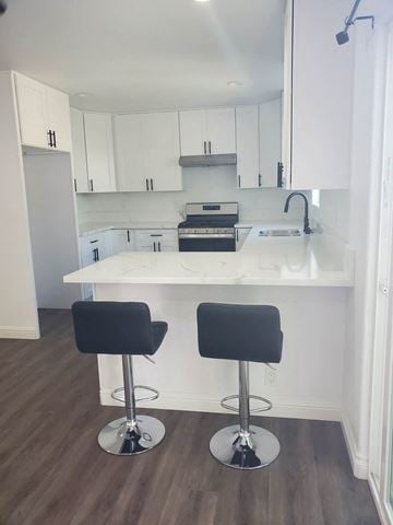 Santa Maria apartment for rent - Two black barstools are in front of a white kitchen island.