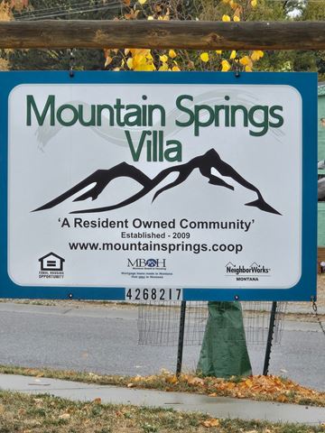 Red Lodge house for rent - A sign for Mountain Springs Villa, a resident-owned community, is displayed on a fence.