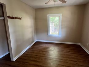 Palatka house for rent - A room with a window and a fan on the ceiling.