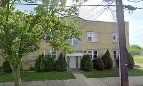 Akron apartment for rent - A tree with green leaves is in front of a house.