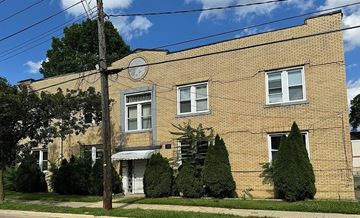 Akron apartment for rent - A brick building with a white door and windows.