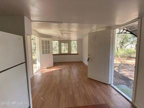 Interlachen house for rent - an empty kitchen and living room with wood floors and a window