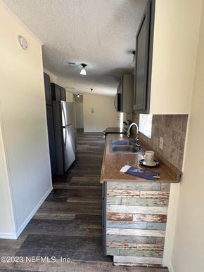 Interlachen house for rent - A kitchen with a refrigerator, sink, and cabinets.