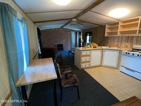 Interlachen house for rent - A living room with a couch, chair, and television.