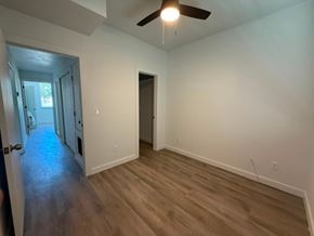San Antonio apartment for rent - A room with a ceiling fan and wooden flooring.