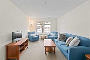 Farmville apartment for rent - a living room with a blue couch and a tv